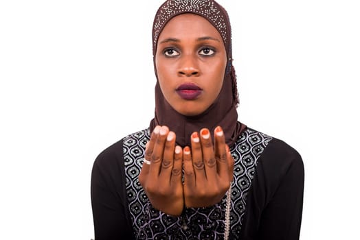 young muslim woman isolated on white background praying.