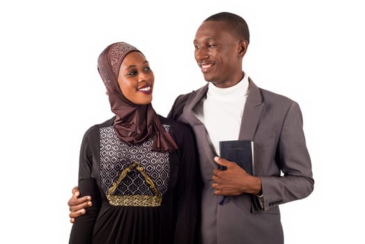 portraits of two religious people embracing standing and smiling on white background.