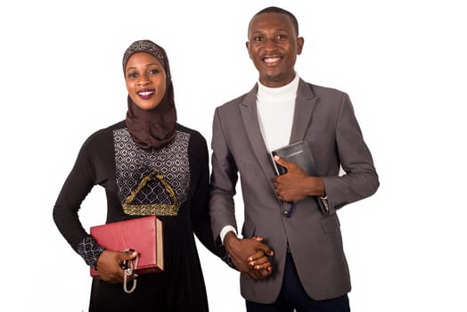 portraits of two religious people holding hands, smiling and holding religious documents.