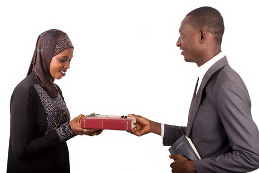 portraits of two smiling religious people holding a book on white background