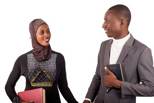 portraits of two religious people holding hands, smiling and holding religious documents.