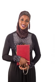portrait of young muslim woman standing and holding a religious document on white background.
