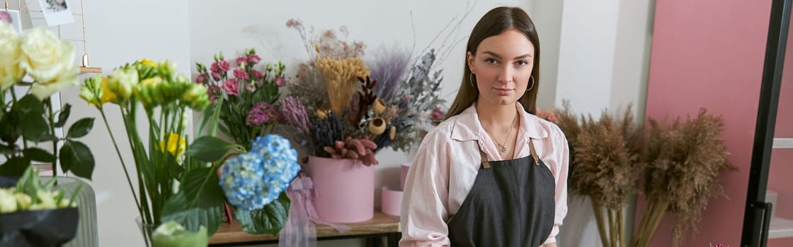 happy professional woman is working in flower shop