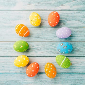 Happy Easter Day Concept. Top view holiday banner background web design white colorful easter eggs painted on blue wood background with empty copy space, celebration greeting card, overhead, template