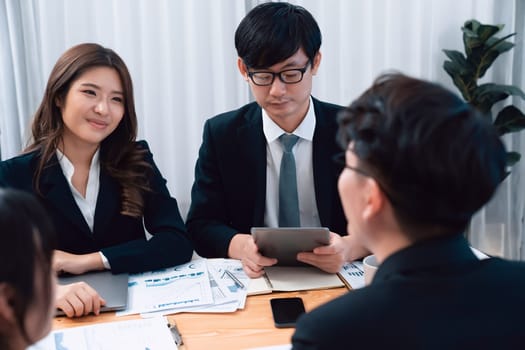 Business team of financial data analysis meeting with business intelligence, report paper and dashboard on laptop for marketing strategy. Business people working together to promote harmony in office.