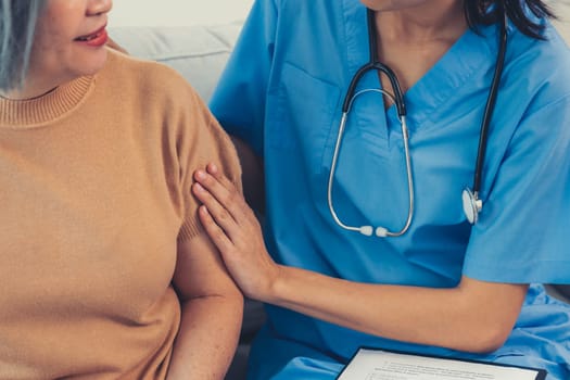 A young caregiver spending time together with a contented senior woman at home. Caregiver being supportive to her patient, Senior nursing at home.