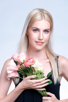 Closeup young personable woman with natural makeup and healthy soft skin holding rose for beauty care advertising in isolated background. Beautiful pretty model girl with flower concept.