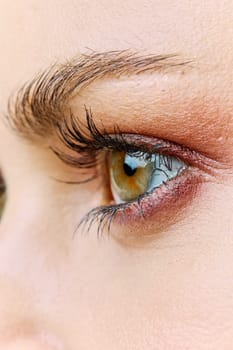 a close-up photo of a woman's eyes, with evening makeup. Vertical photo without retouching. High quality photo