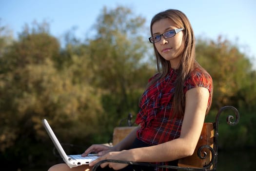 Young woman in glasses look at you