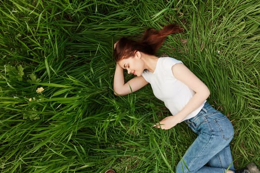 calm, peaceful woman falls asleep in tall grass. High quality photo