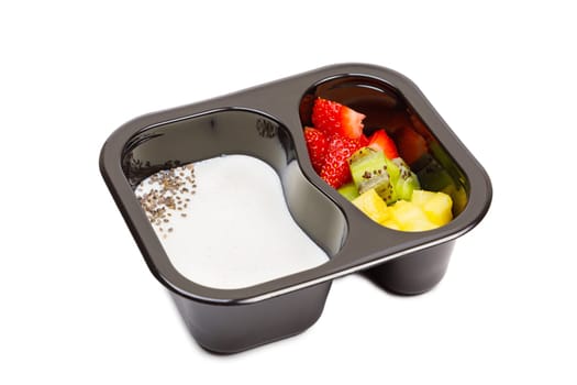 Portion of yogurt dessert with strawberry and kiwi and pineapple in a plastic bowl. High quality photo