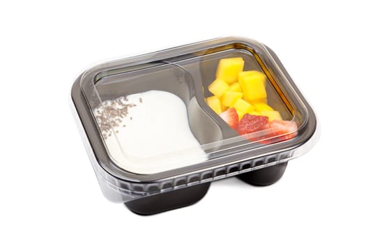 Portion of yogurt dessert with strawberry and mango in a plastic bowl. High quality photo