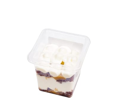 Portion of chocolate caramel mousse in a plastic cup on a white background. High quality photo