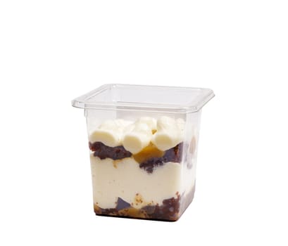 Portion of chocolate caramel mousse in a plastic cup on a white background. High quality photo