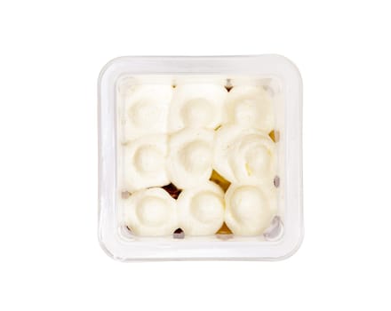 Portion of chocolate caramel mousse in a plastic cup on a white background. High quality photo. View from above.