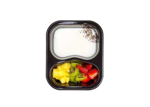 Portion of yogurt dessert with strawberry and kiwi and pineapple in a plastic bowl. View from above. High quality photo.