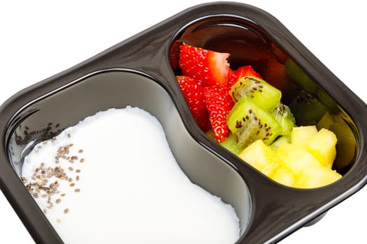 Portion of yogurt dessert with strawberries, kiwi and pineapple in a plastic bowl. High quality photo.