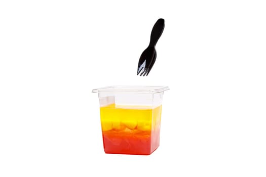 Grapefruit, mango and raspberry jelly in a plastic cup on a white background. High quality photo