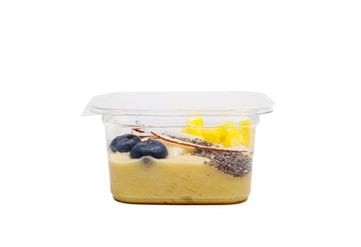 Smoothies with fresh fruits and nuts. Pineapple puree, banana. Pieces of coconut with blueberries. High quality photo. Side view.