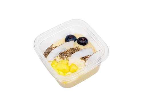 Smoothies with fresh fruits and nuts. Pineapple puree, banana. Pieces of coconut with blueberries. High quality photo