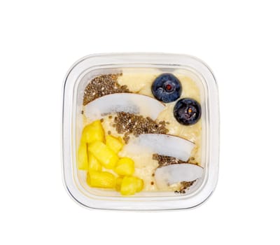 Smoothies with fresh fruits and nuts. Pineapple puree, banana. Pieces of coconut with blueberries. High quality photo. View from above.