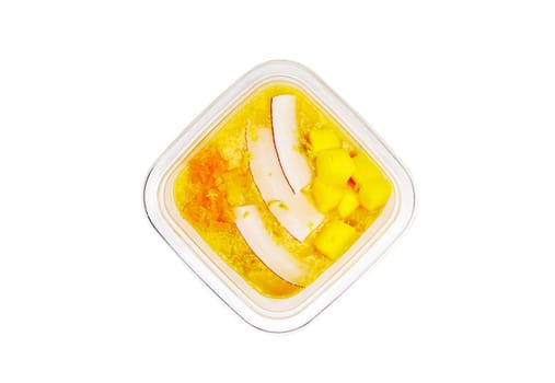 Smoothies with fresh fruits and nuts. Smoothie bowl, mango, passion fruit, coconut. Applesauce, lemon zest. High quality photo.