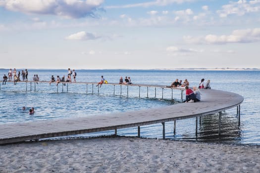 Aarhus, Denmark, July 2018: people rest on a round pier in Denmark.