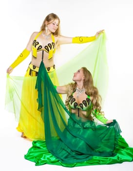 two young girl dance with green veil - traditional arabic costume