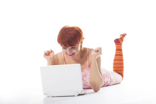 Girl in striped socks look at notebook and smile at white background