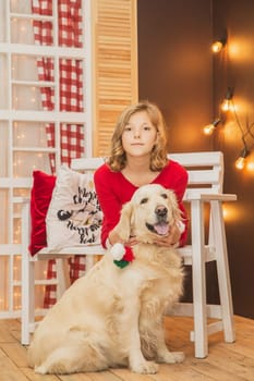 Blonde teenager and her dog are hugging on the porch.