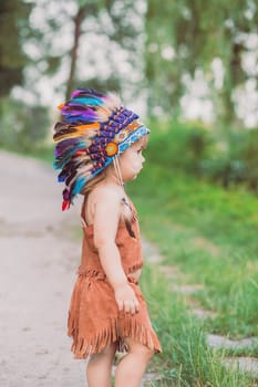 Cute baby dressed in traditional Native American costume.