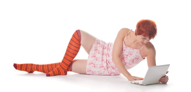 Red Girl in stripe socks with laptop on white background