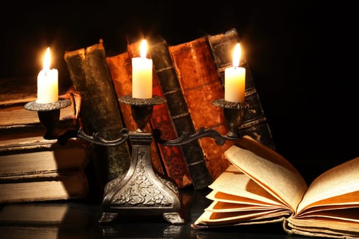 Nice vintage candlestick on background with old books