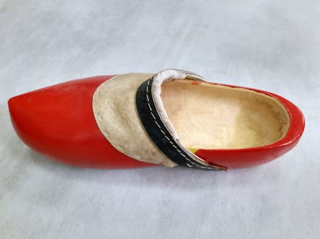 Big red dutch wooden shoe close up. Wooden shoe.