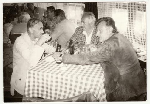 THE CZECHOSLOVAK SOCIALIST REPUBLIC - CIRCA 1950s: Retro photo shows men in the pub - inn. Vintage black and white photography.