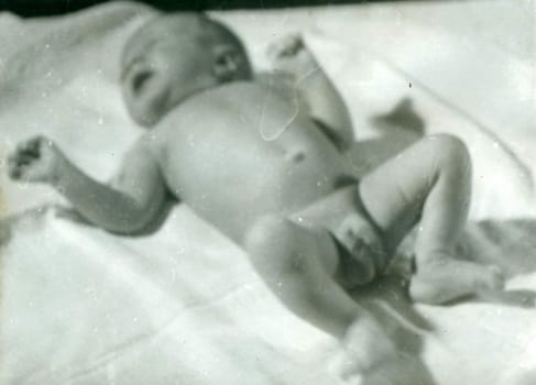 THE CZECHOSLOVAK SOCIALIST REPUBLIC - 1959: Retro photo shows newborn baby. Vintage black and white photography. Note: blurriness, better at smaller sizes.