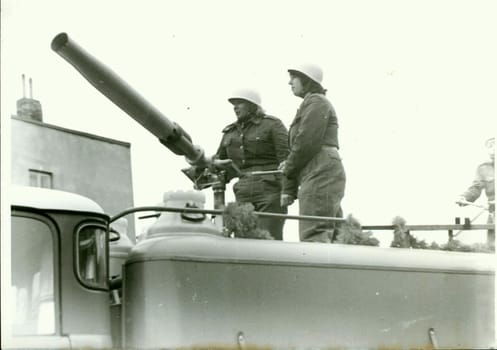 THE CZECHOSLOVAK SOCIALIST REPUBLIC - CIRCA 1980s: Retro photo shows firemen stand on the top of fire truck. Vintage black and white photography. Note: blurriness, better at smaller sizes.