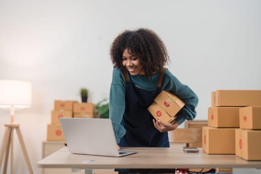 Young attractive woman owner startup business work happy with box at home prepare parcel delivery in sme supply chain, online delivery idea concept.