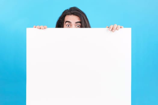 Studio portrait of a man holding a board with blank space