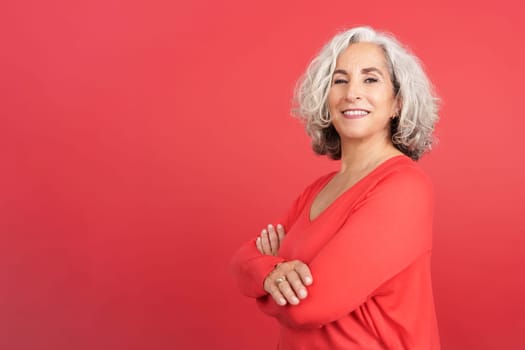 Studio portrait with red background of a