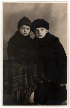 THE CZECHOSLOVAK REPUBLIC - DECEMBER 23, 1922: Vintage photo shows two small boys - 2 and 8 years old. Retro black and white photography.