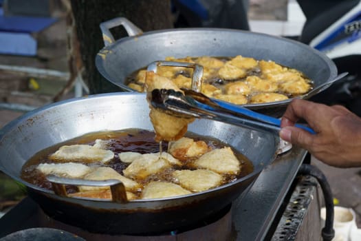 Pan Frying process of the Indonesian street vendors for the meals as the breakfasting time in Ramadhan.