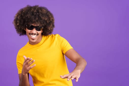 Cool african man with curly hair rapping in sunglasses in studio