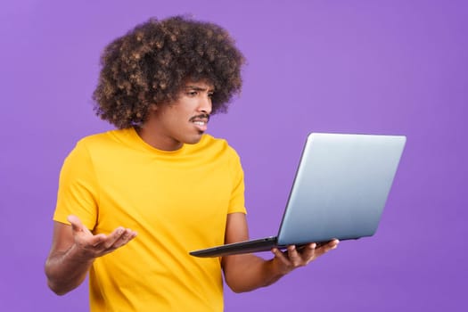 African man with a laptop gesturing that there is a problem in studio