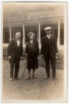 THE CZECHOSLOVAK REPUBLIC - CIRCA 1930s: Vintage photo shows two men and woman pose outside. Original retro black and white photography.