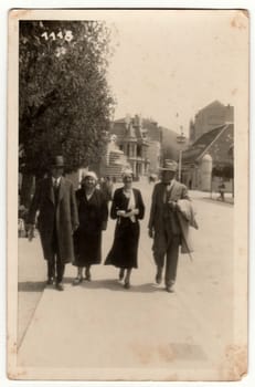 TRENCIANSKE TEPLICE, THE CZECHOSLOVAK REPUBLIC - CIRCA 1930s: Vintage photo shows women and men at the spa resort. Original retro black and white photography.