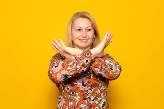 Stop don't move, Portrait of blonde caucasian woman cross hands x sign reject choice decisions wear good looking outfit isolated over yellow color background