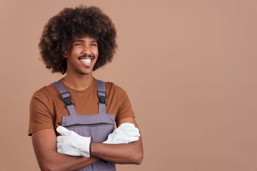 Happy smiley afro man carpentry worker with tools and work uniformin studio