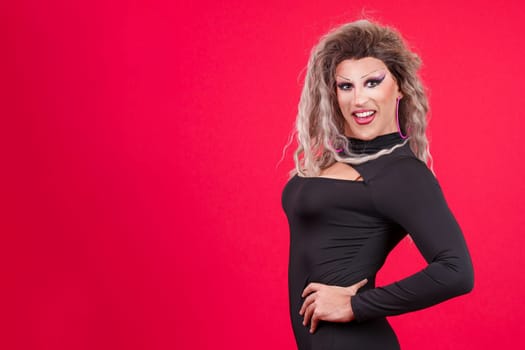 Slim transgender person with make up smiling at camera while posing