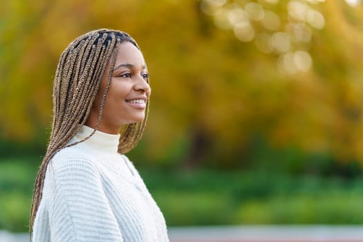 Photo with copy space of the profile of an african woman looking up in a park